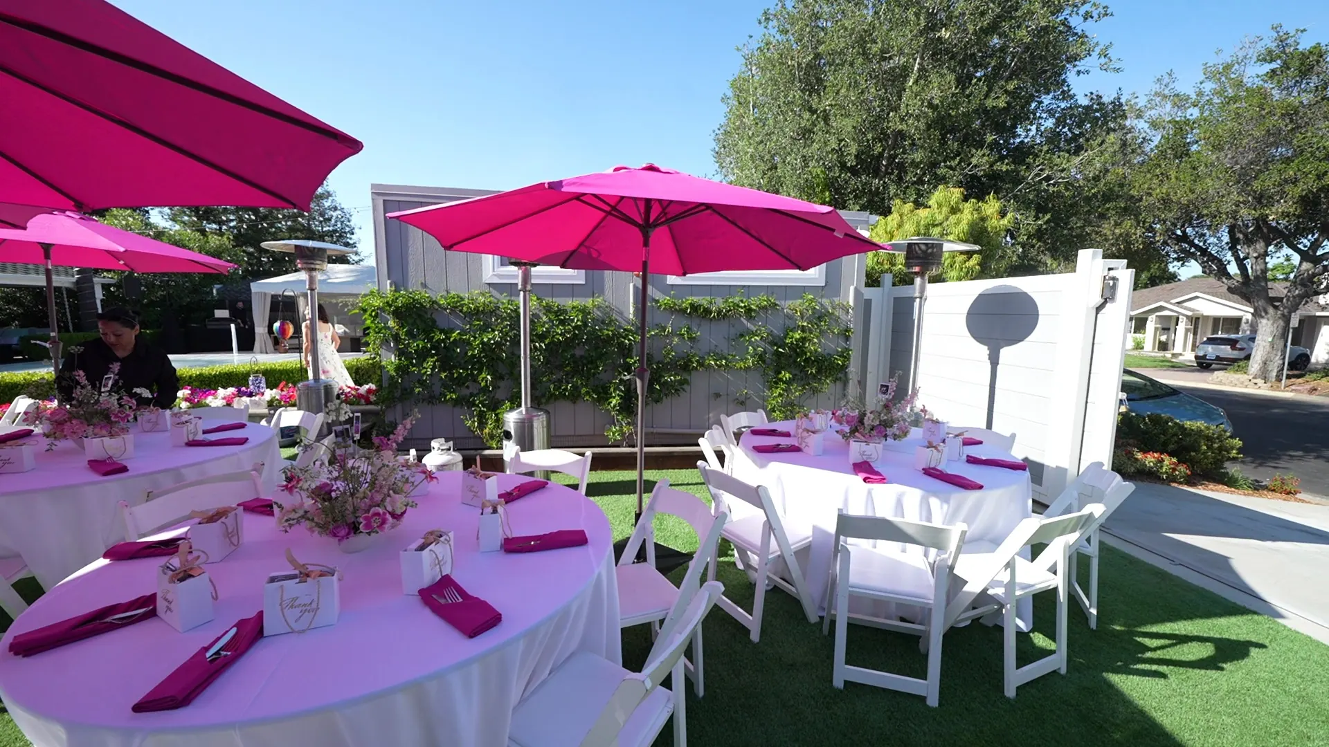 Long banquet tables with umbrellas and patio heaters at a Daly City catered celebration