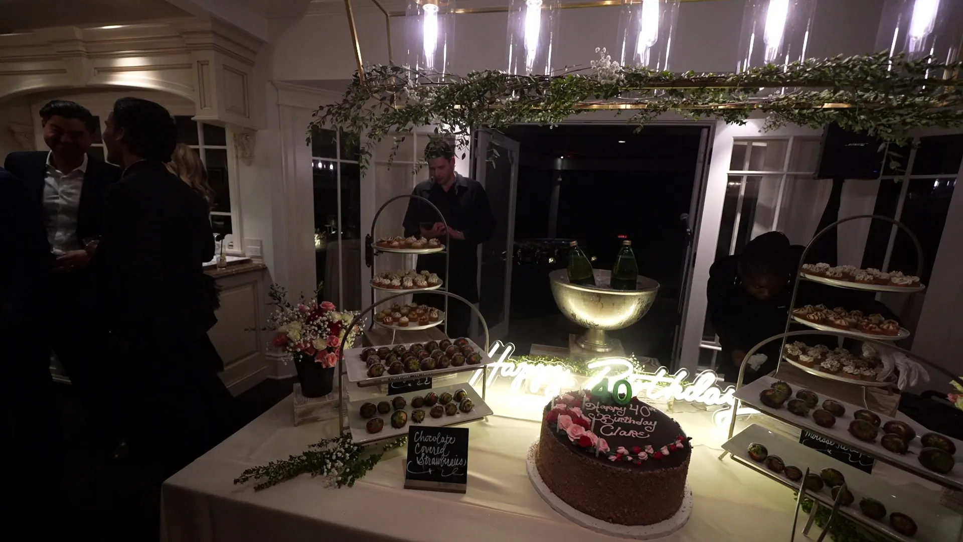 Catering Brisbane — lit birthday dessert display with cake, mini pastries and chocolate strawberries