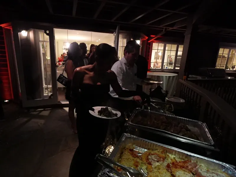 Guests serving themselves from a hot buffet at an evening South San Francisco catered reception