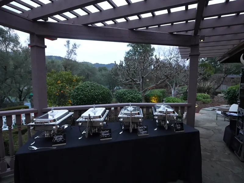 Catering South San Francisco — chafing dish line with menu cards on a hillside terrace