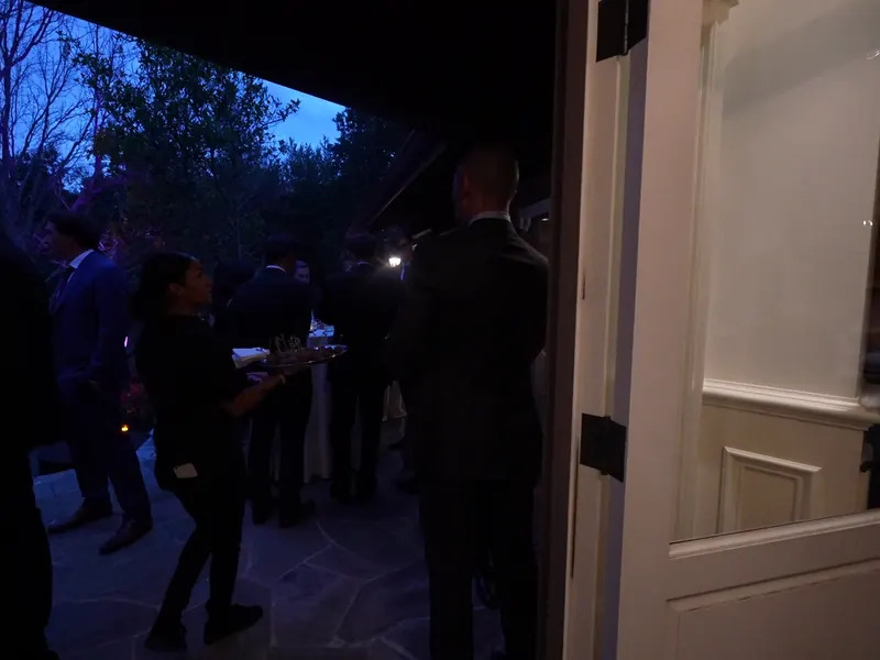 Server passing appetizers to guests at dusk during a South San Francisco cocktail hour