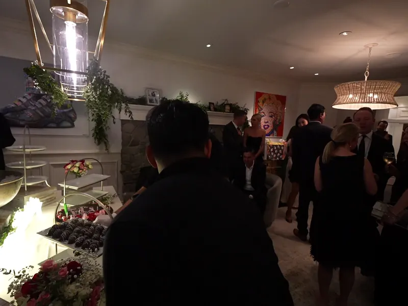 Guests mingling around a dessert and appetizer display at an indoor Daly City cocktail reception