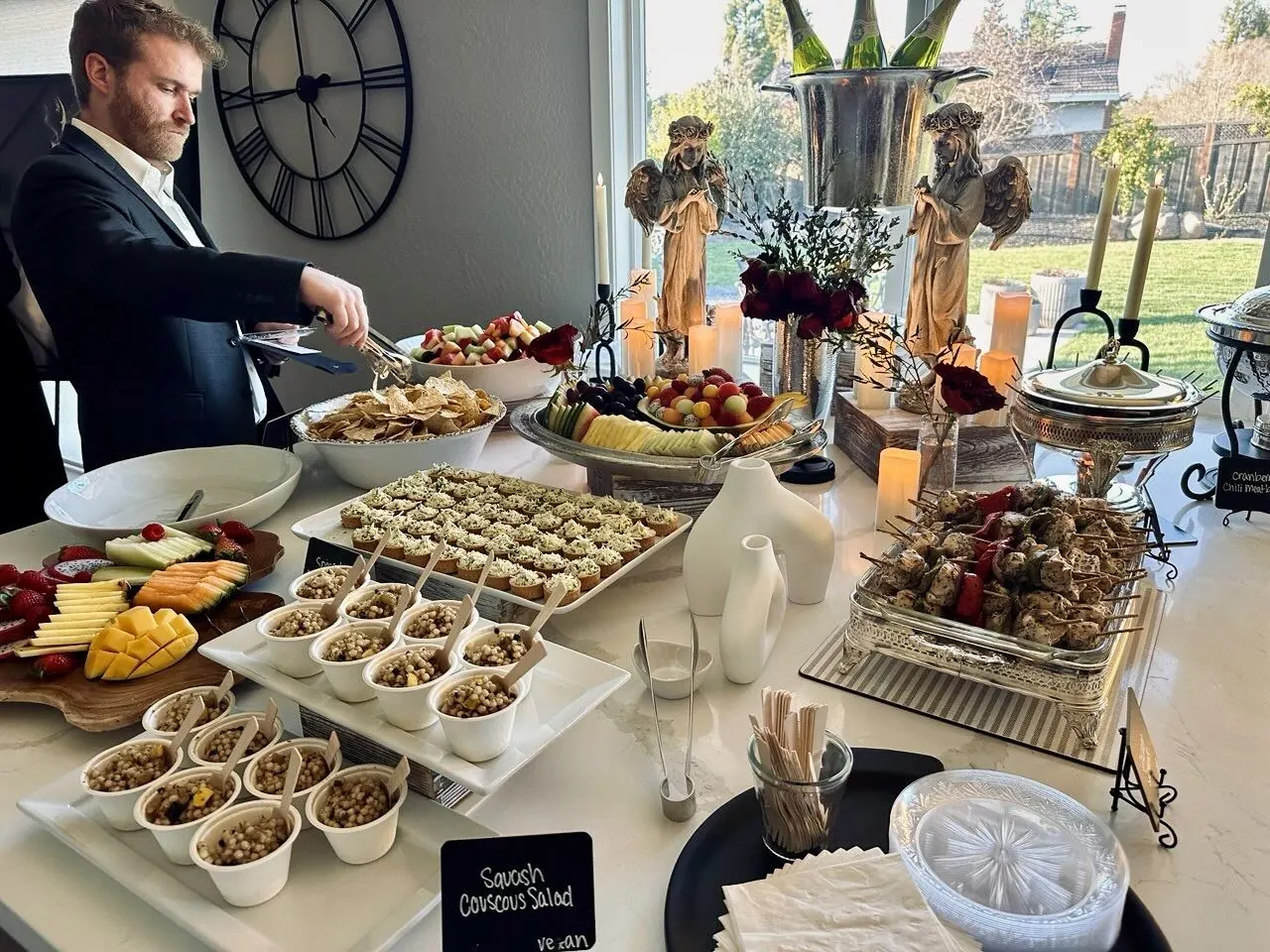White-linen appetizer buffet with couscous salad, a sliced fruit platter and grilled skewers — corporate appetizer catering in SF