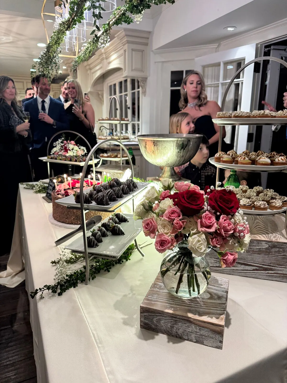 Wedding dessert table with cake, tarts, and chocolate-dipped strawberries at a San Francisco reception by SF Catering Company